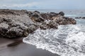 Volcanic rock at black sand beach in Padangbai, Bali Island, Indonesia Royalty Free Stock Photo