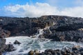 Volcanic Rocks on Hawaiian Coastline with Ocean Wave Royalty Free Stock Photo