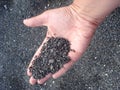 Volcanic sand in hand in Santorini island i Royalty Free Stock Photo