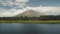 Volcano erupt at green lake shore aerial. Philippines coutryside of Legazpi town at greenery meadows