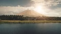 Volcano erupt at sun shine over lake shore aerial. Philippines coutryside of Legazpi town at valley Royalty Free Stock Photo