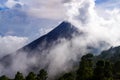 Volcano Fuego covered by clouds and mist