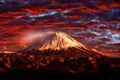 Volcano Fuji during beautiful sunset, red clouds on the sky. Active hill with eruption, twilight in Japan. Mount Fuji, San,