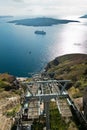 Volcano island with cruisers anchored around, a view from ropeway above port of Fira at Santorini Royalty Free Stock Photo