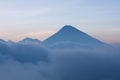 Volcano next to Pacaya surrounded by clouds in the evening, Guatemala Royalty Free Stock Photo
