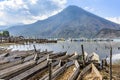 Volcano & traditional boats by lakeside, Santiago Atitlan, Lake Atitlan, Guatemala