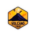 Volcano yellow sky badge with rocky shape and smoke of volcano explosion