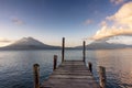 Volcanoes and dock on lake Atitlan at sunrise