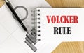 VOLCKER RULE text on notebook with pen and chart