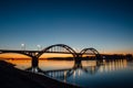 Volga bridge over Volga river after sunset with reflection in water, Yaroslavl region, Rybinsk city, Russia Royalty Free Stock Photo