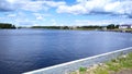 Volga river with a piece of beach and houses in the background and pretty clouds in the sky Royalty Free Stock Photo