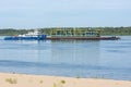 Volgograd, Russia - August 27, 2019: Transportation by a tugboat of a floating platform with technological equipment