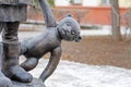 Fragment of monument `Children of military Stalingrad` with a teddy bear standing on Lenin Square