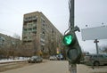 Broken traffic light dangles on a pole and lights up green