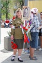 Female nurse in uniform of World War II with portrait of relative in the action `Immortal regiment` on Victory day in Volgograd