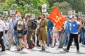 Soviet female soldier with participants of the action `Imortal Regiment` walking along the street on Victory day in Volgograd