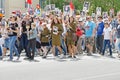 Soviet female soldiers in uniform with participants of the action `Immortal Regiment` walking along street on Victory day in V