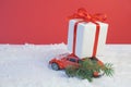 Volgograd, Russia - October 15, 2021: Red retro toy car delivering Christmas or New Year gifts and a Christmas tree tree Royalty Free Stock Photo
