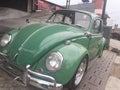 Volkswagen beetle 1300 car parked outside an antique service workshop