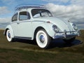 1965 Volkswagen beetle with coluds in the sky