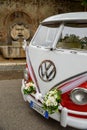 Volkswagen Camper van Wedding with bows and wedding flowers Rome  Italy. Royalty Free Stock Photo