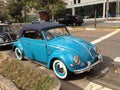 Volkswagen convertible vintage Beetle. Light blue with roof, retro car parked