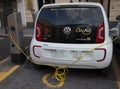 Volkswagen e-Up plug-in hybrid electric car stands by charging station, in Genoa, Italy.