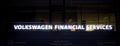 Volkswagen Financial Services illuminated billboard with the name of the financial institution in the pedestrian zone of Wolfsburg