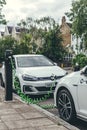 Volkswagen Golf GTE charging at a charging point on a street in London Royalty Free Stock Photo