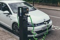 Volkswagen Golf GTE charging at a charging point on a street in London Royalty Free Stock Photo