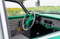 Volkswagen Karmann Ghia vintage radio on dashboard with classic gauge and white steering wheel. Retro car with pastel Royalty Free Stock Photo