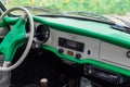 Volkswagen Karmann Ghia vintage radio on dashboard with classic gauge and white steering wheel. Retro car with pastel Royalty Free Stock Photo