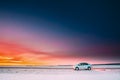 Volkswagen Polo Car Sedan Parking On A Roadside Of Country Road On A Background Of Dramatic Sunset Sky At Winter Season