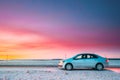Volkswagen Polo Car Sedan Parking On A Roadside Of Country Road On A Background Of Dramatic Sunset Sky At Winter Season
