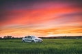 Volkswagen Polo Vento Car Sedan On Country Road In Spring Wheat Field Under Colorful Dramatic Sky At Sunset Or Sunrise Royalty Free Stock Photo