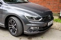 Volkswagen trade wind of gray color. Business sedan parked near a building on the street.