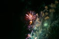 Volley of festive fireworks, red-yellow, with haze, in the night sky Royalty Free Stock Photo