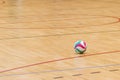 Volleyball ball on hardwood volleyball court