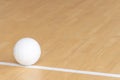 Volleyball ball on hardwood court floor with natural lighting Royalty Free Stock Photo