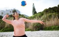 Volleyball, beach and spike with a sports woman playing a game outdoor in nature alone for recreation. Fitness, exercise Royalty Free Stock Photo