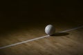Volleyball court wooden floor with ball on black with copy-space Royalty Free Stock Photo