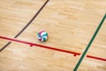 Volleyball court wooden floor with ball isolated on black with copy-space