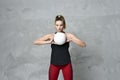 Volleyball girl hold and kick ball in black costume on grey concrete wall background Royalty Free Stock Photo