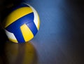 Volleyball on hardwood floor Royalty Free Stock Photo