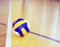 Volleyball on hardwood floor Royalty Free Stock Photo