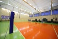 Volleyball net inside lighted school gym hall Royalty Free Stock Photo