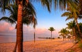 Volleyball net on a tropical beach with palm trees at scenic sunset in Miami, Florida Royalty Free Stock Photo