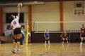 Volleyball player serves the ball