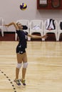 Volleyball player serves the ball