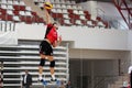 Volleyball player serves the ball